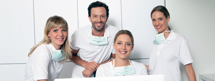 4 dentists in white shirts and masks