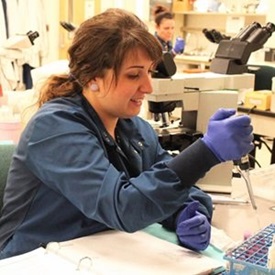 woman in lab with gloves 